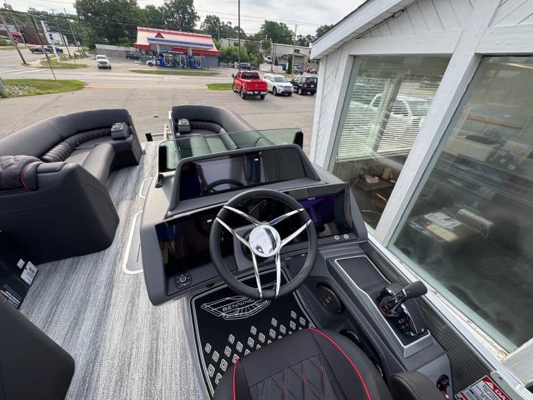 Bennington 25 RSBA luxury pontoon boat with modern dashboard and steering wheel.