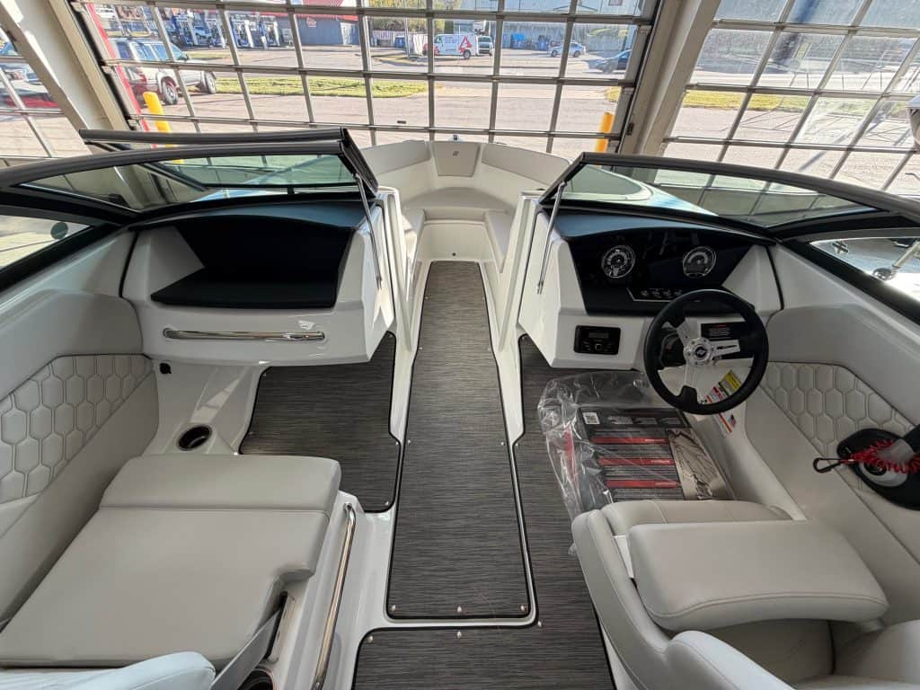 Luxury boat cockpit with modern controls and seating.