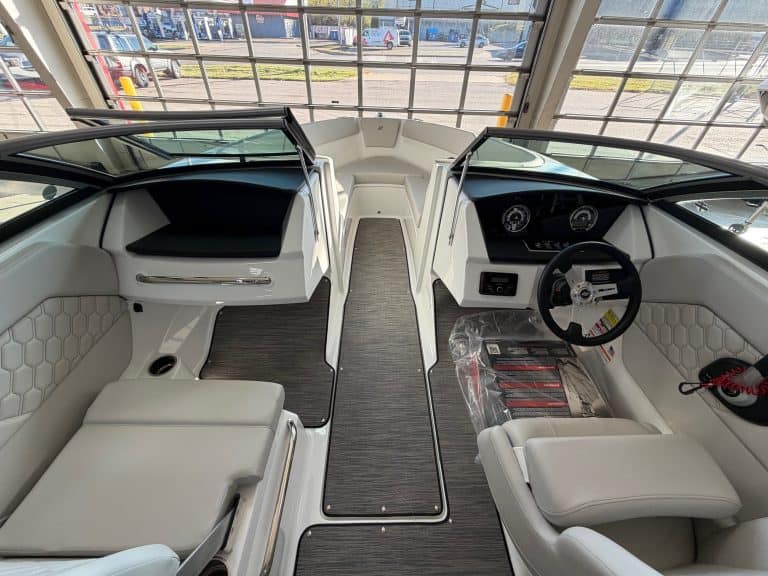 Luxury boat cockpit with modern controls and seating.