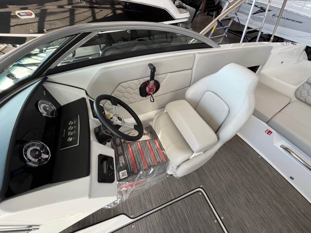 Luxury boat cockpit with modern controls and white seating at Hall's Sport Center.