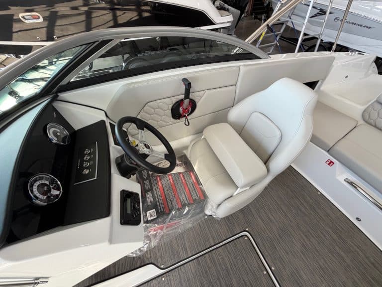 Luxury boat cockpit with modern controls and white seating at Hall's Sport Center.