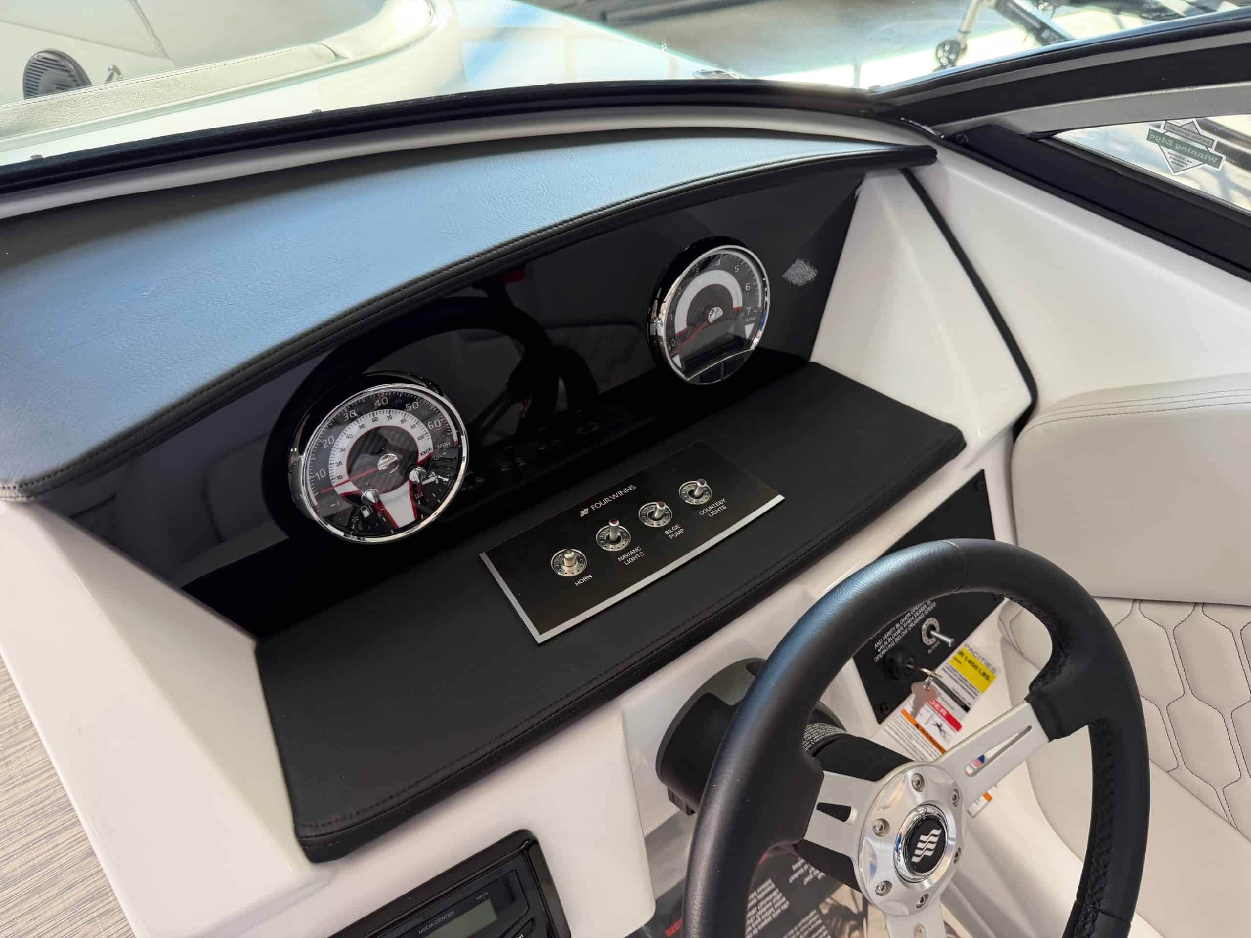 Interior dashboard of the 2026 Four Winns H1 Freedom boat at Hall's Sport Center.