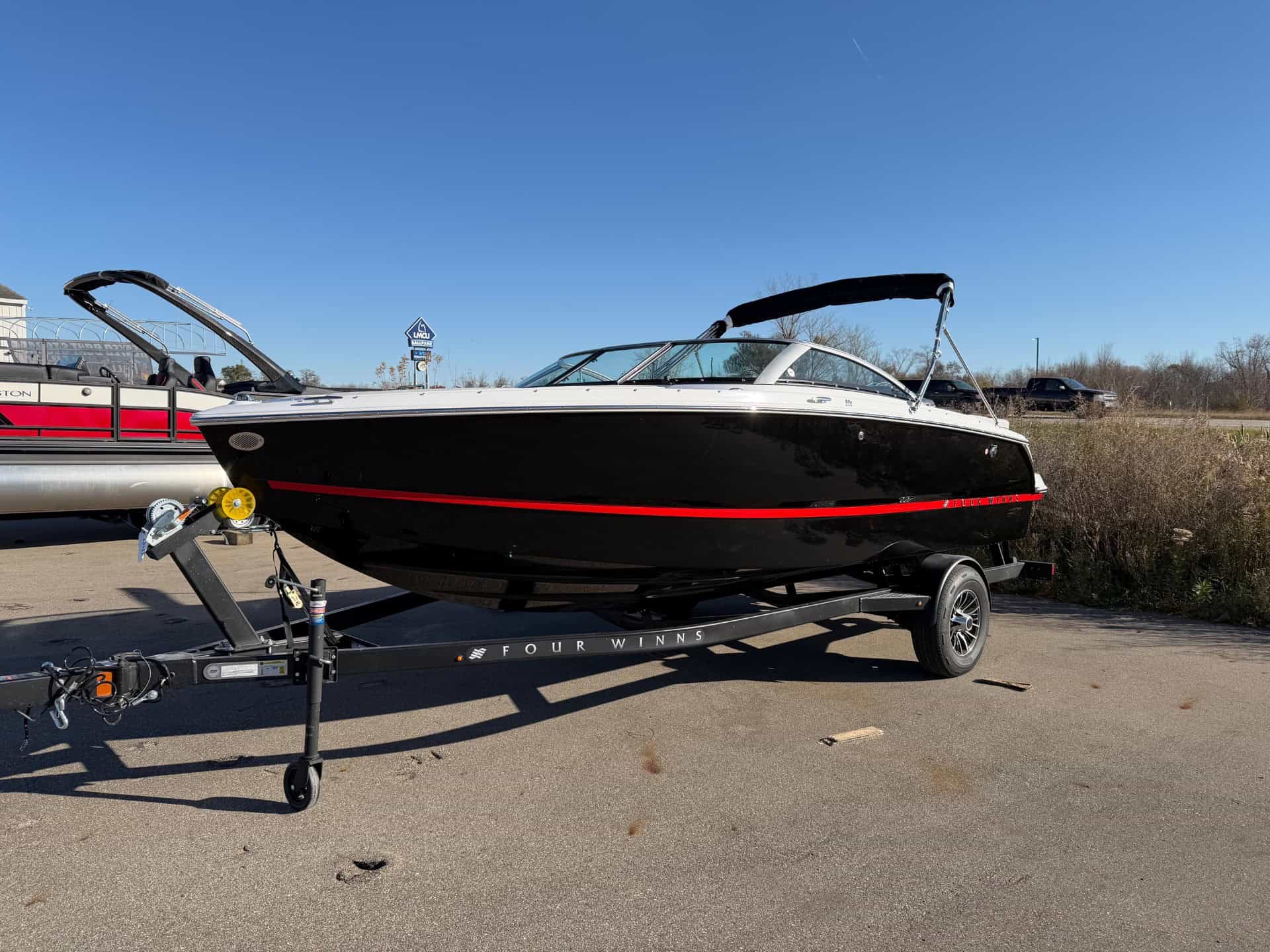 Four Winns H1 Freedom boat on trailer at Hall's Sport Center.
