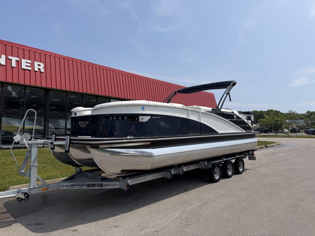 Luxury motorboat on trailer parked outside Hall's Sport Center, showcasing premium watercraft and bo.