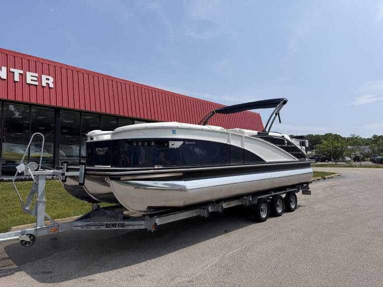 Luxury motorboat on trailer parked outside Hall's Sport Center, showcasing premium watercraft and bo.