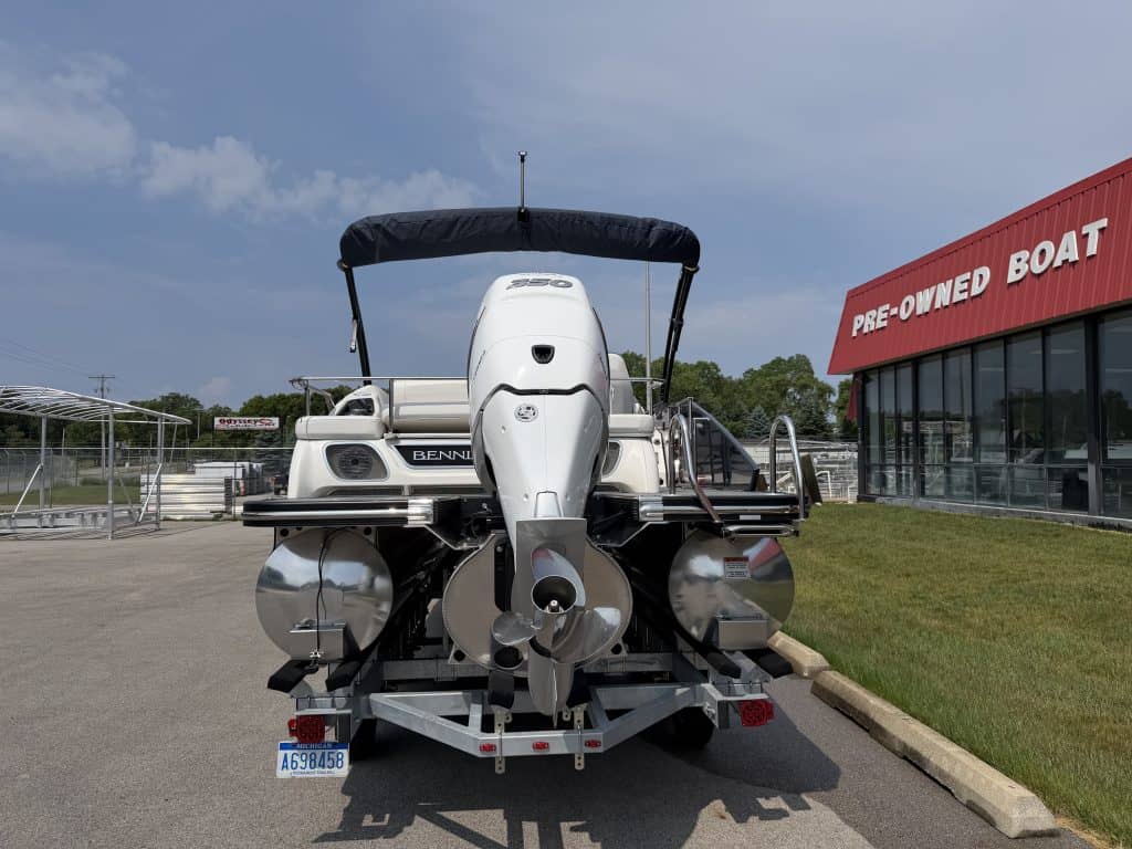 Pontoon boat with powerful outboard motor for water recreation at Hall's Sport Center.