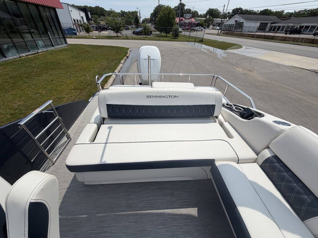 Boat lounge with comfortable seating and a Bennington outboard motor, ideal for relaxing after water.