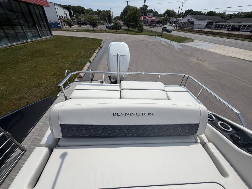 Bennington pontoon boat with outboard motor at Hall's Sport Center, perfect for leisure and water sp.