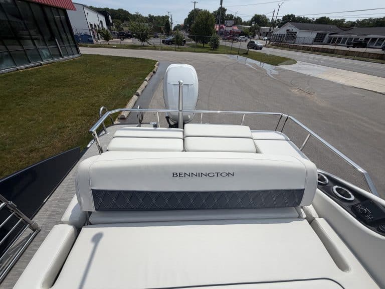 Bennington pontoon boat with outboard motor at Hall's Sport Center, perfect for leisure and water sp.