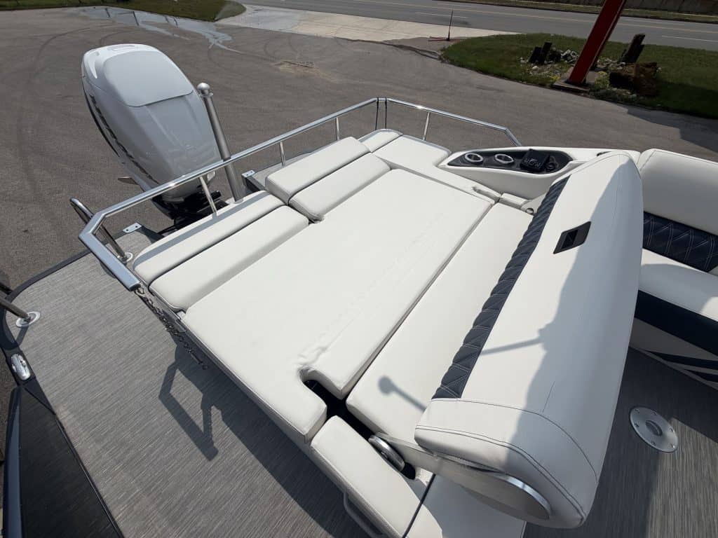 Comfortable boat lounge with cushioned seating and sunbathing area at Hall's Sport Center marina.
