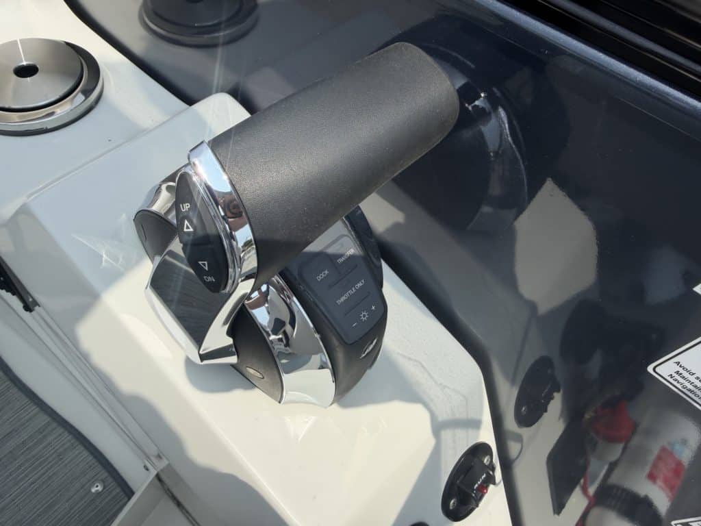 Golf cart steering wheel with control buttons and dashboard.