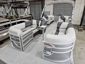 Bennington 22 SSR pontoon boat with seating and canopy in showroom.