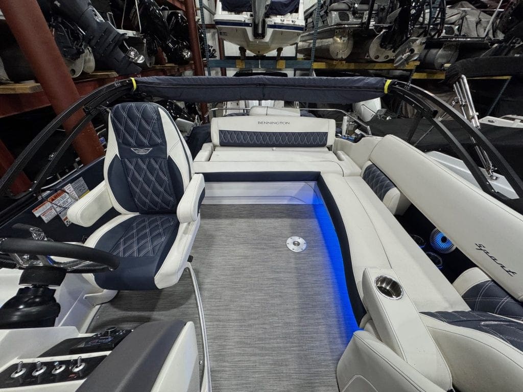 Bennington 23 RXSB pontoon boat with modern seating and blue LED lighting.