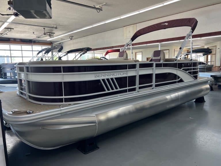 Modern Bennington 23 LSR pontoon boat displayed indoors at Hall's Sport Center.