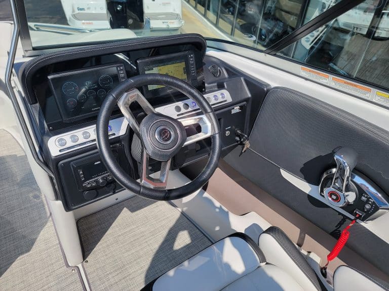 Interior view of the 2024 Crownline 240 SS boat dashboard and steering wheel.