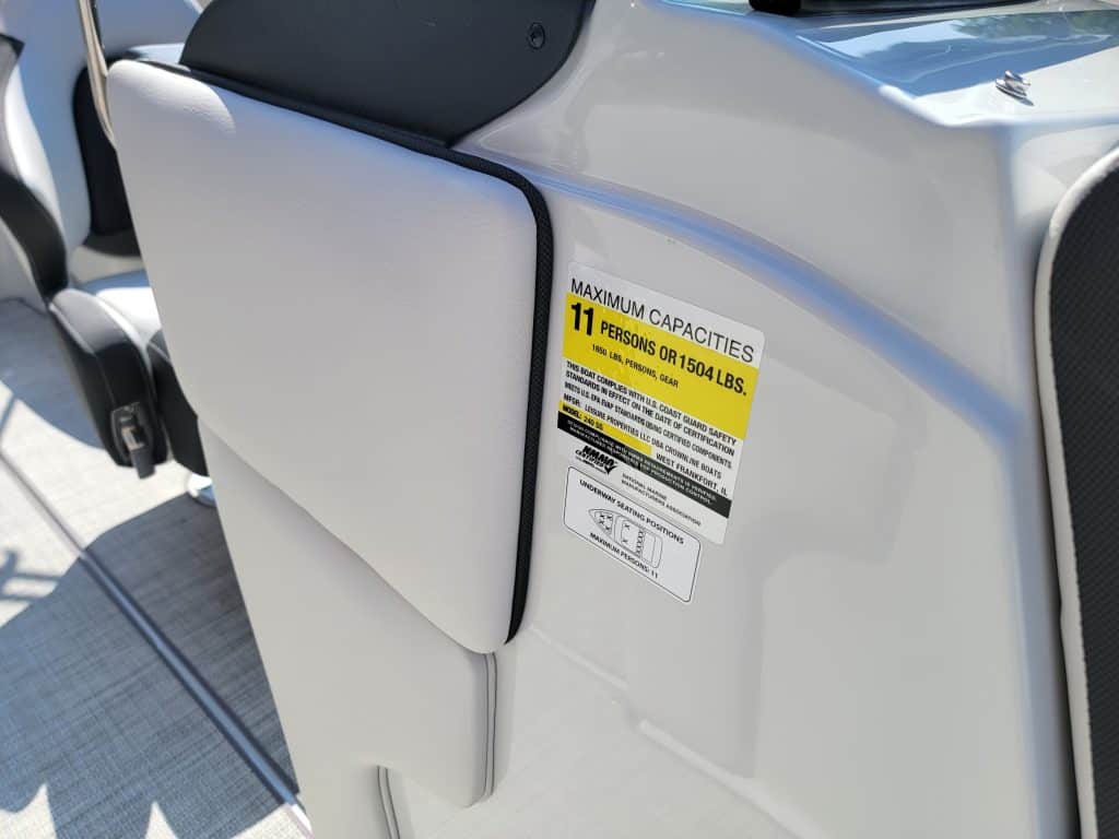 Close-up of maximum capacity label on Crownline 240 SS boat seat.