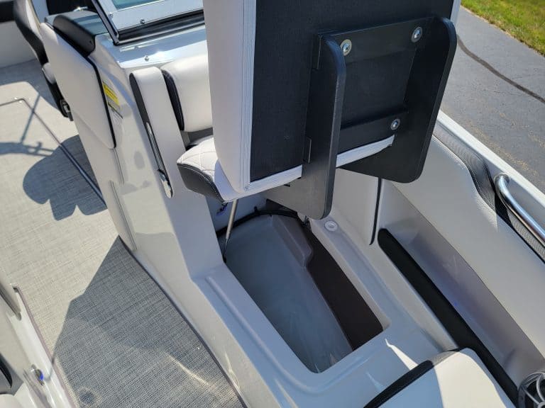 Crownline 240 SS boat interior with storage compartment and seating.