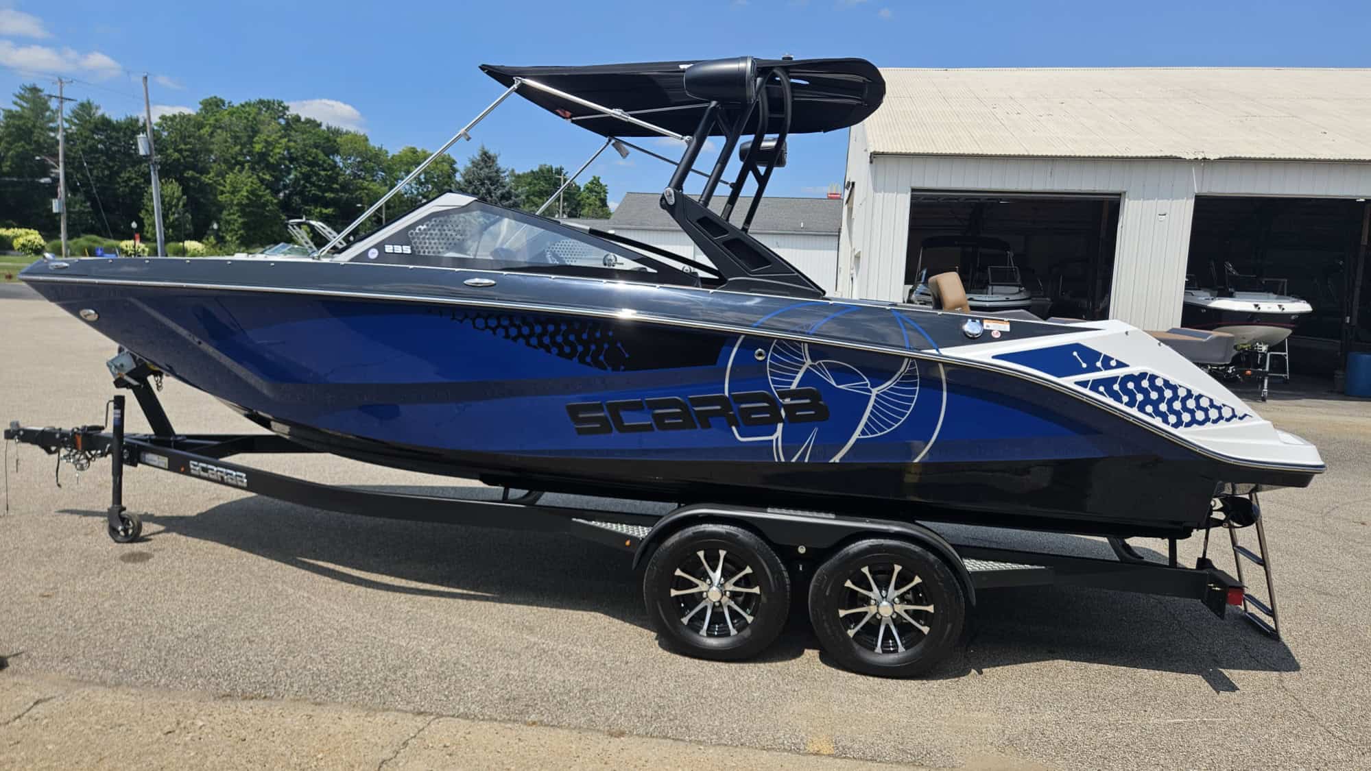 Scarab 235 ID speedboat on trailer at Hall's Sport Center.
