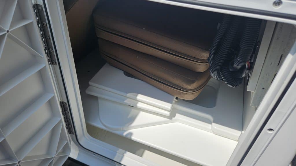 Storage compartment of the 2024 Scarab 235 ID boat at Hall's Sport Center.