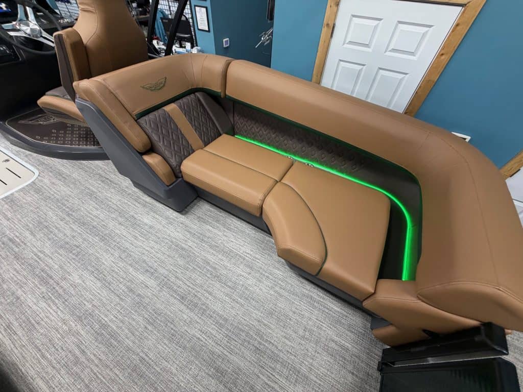 Luxury boat seating with brown leather and green LED accents.