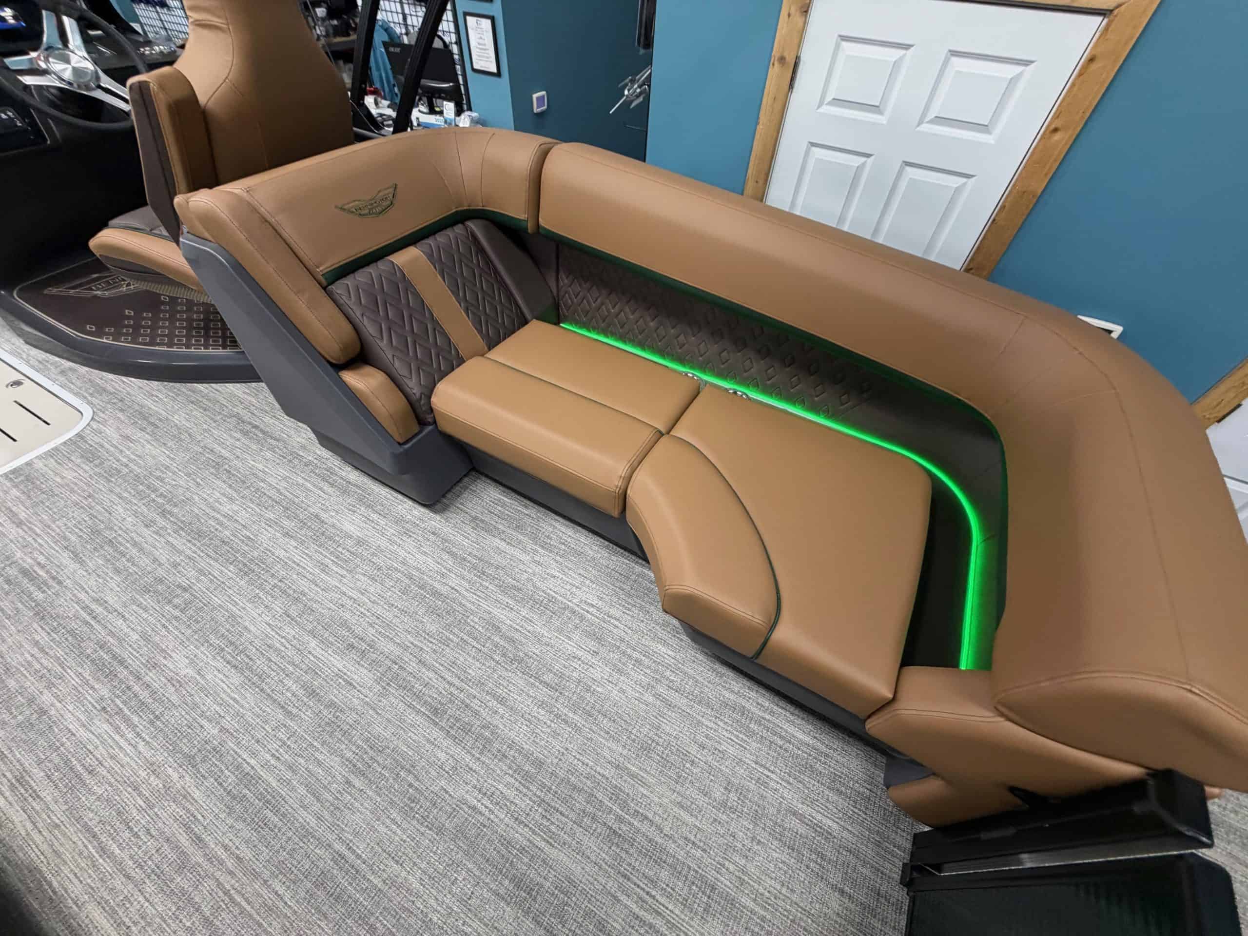 Luxury boat seating with brown leather and green LED accents.