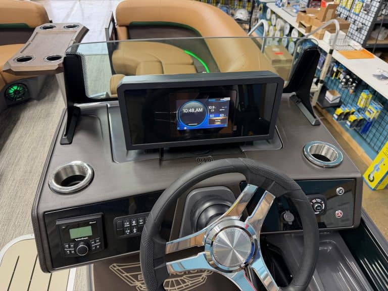 Bennington 22 MFB boat dashboard with touchscreen display and steering wheel.