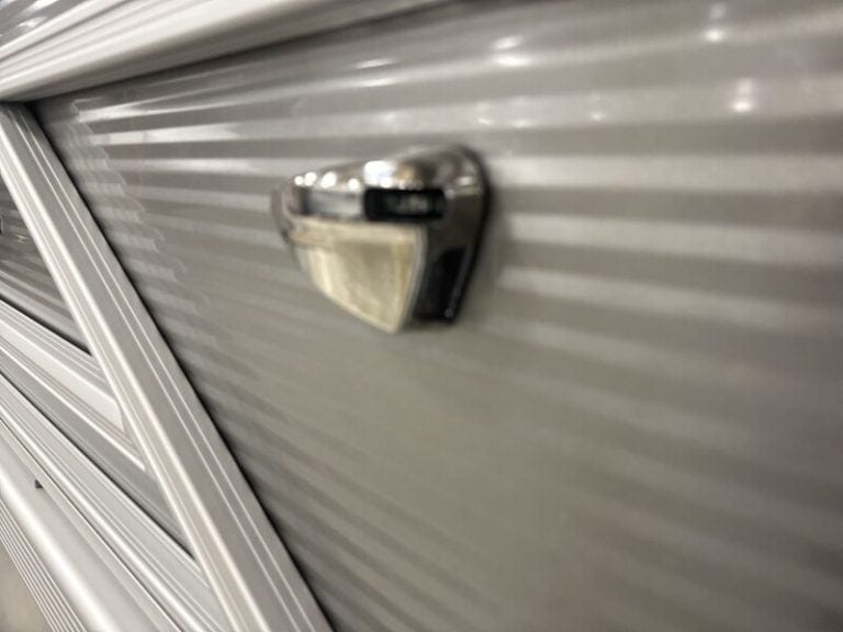 Close-up of a boat trailer lock on a silver boat hull at Hall's Sport Center.