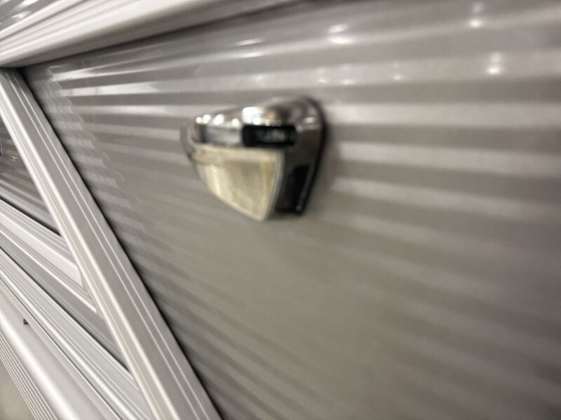Close-up of a boat trailer lock on a silver boat hull at Hall's Sport Center.