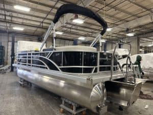 Bennington 22 SSR pontoon boat displayed at Hall's Sport Center, ideal for leisure and water adventu.