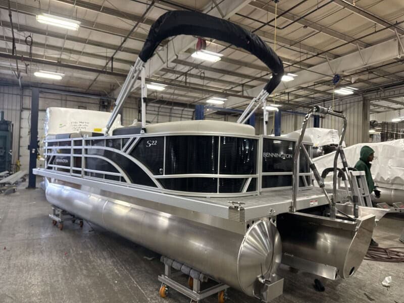 Bennington 22 SSR pontoon boat displayed at Hall's Sport Center, ideal for leisure and water adventu.