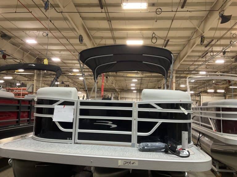 Bennington 22 SSR pontoon boat with black canopy at Hall's Sport Center.