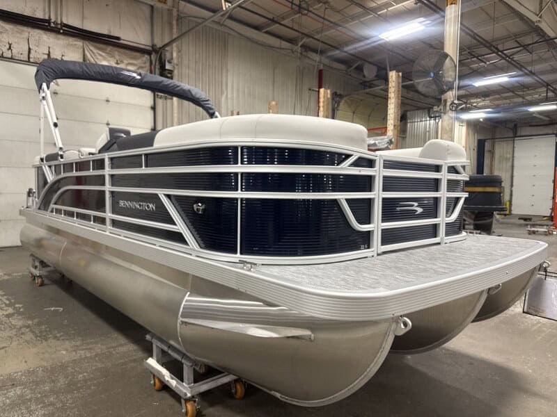 Modern Bennington 22 SSR pontoon boat displayed indoors at Hall's Sport Center.