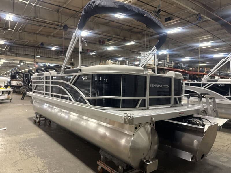 Bennington 22 SSR pontoon boat displayed at Hall's Sport Center, perfect for family fun and water ad.