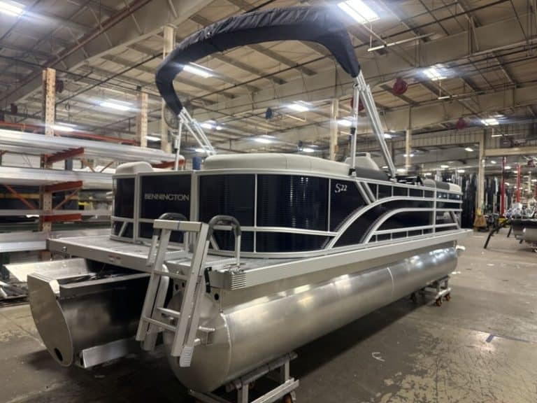Bennington 22 SSR pontoon boat in showroom at Hall's Sport Center, perfect for family fun and water.