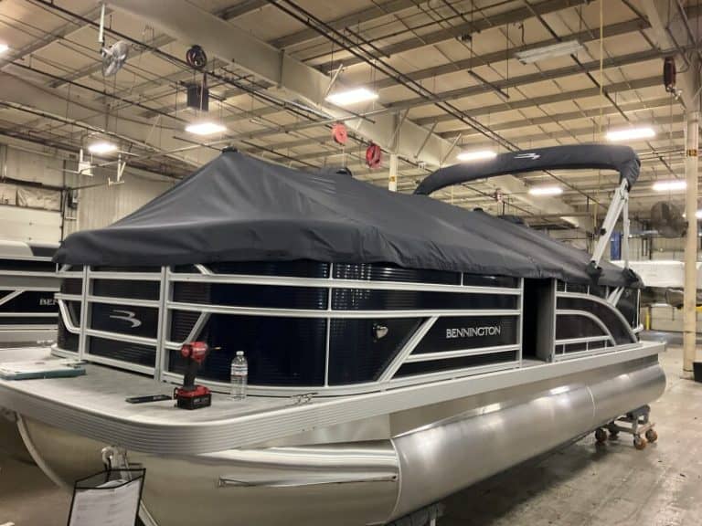 Bennington 22 SSR pontoon boat displayed at Hall's Sport Center, perfect for family outings and wate.