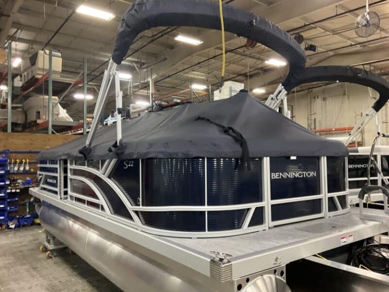 Bennington 22 SSR pontoon boat displayed at Hall's Sport Center, ideal for family boating.