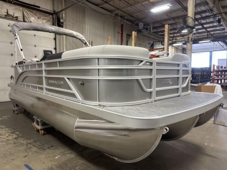 Modern Bennington 22 SSR pontoon boat in showroom setting.