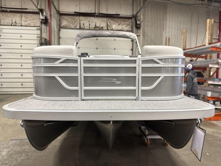 Modern Bennington 22 SSR pontoon boat in showroom setting.