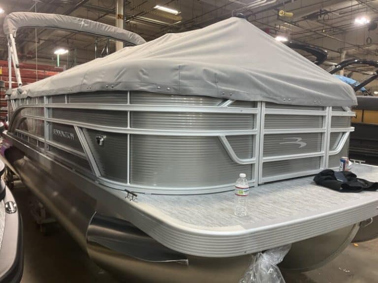 Bennington 22 SSR pontoon boat displayed at Hall's Sport Center, ideal for family boating.