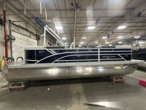 Bennington 22 SSR pontoon boat displayed at Hall's Sport Center, perfect for family fun and water ad.