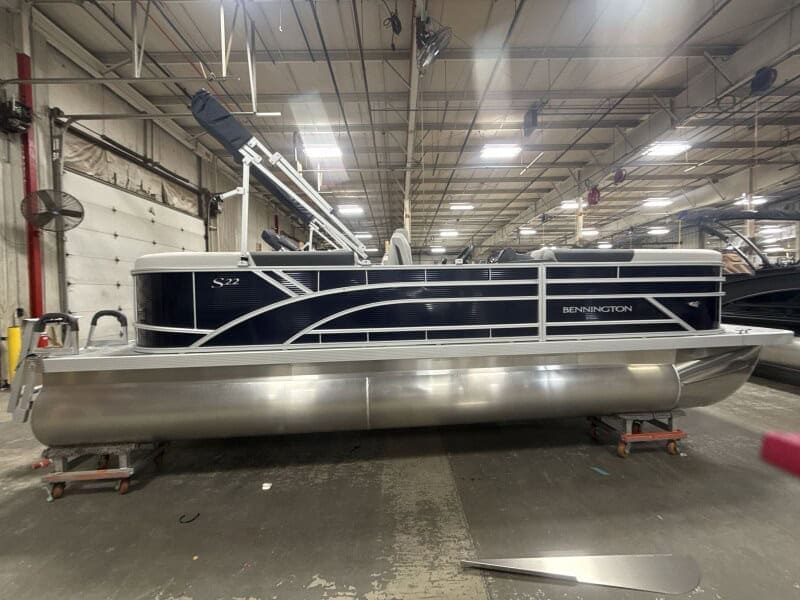 Bennington 22 SSR pontoon boat displayed at Hall's Sport Center, perfect for family fun and water ad.