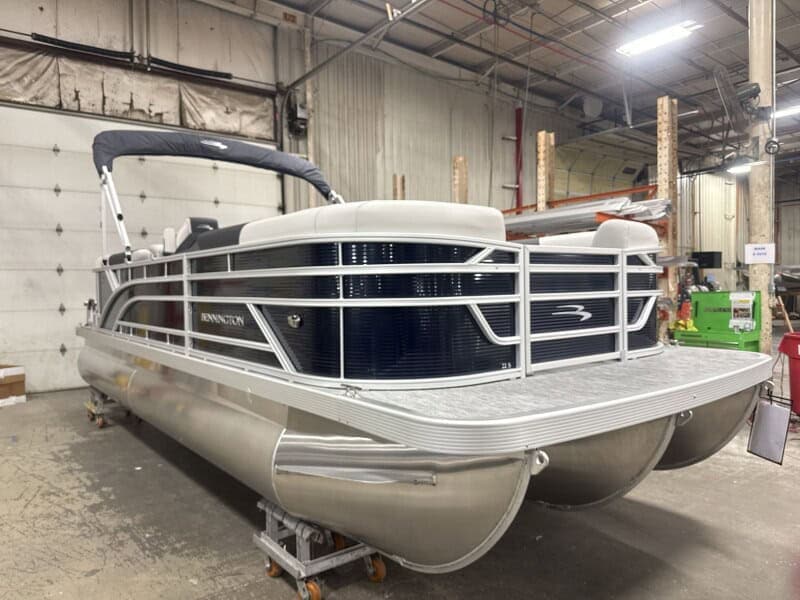 Bennington 22SSR S1 pontoon boat in showroom at Hall's Sport Center.