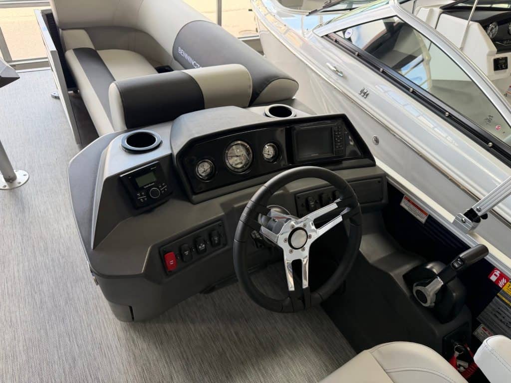 Boat helm with steering wheel, gauges, and controls for Bennington 22SSR S1.