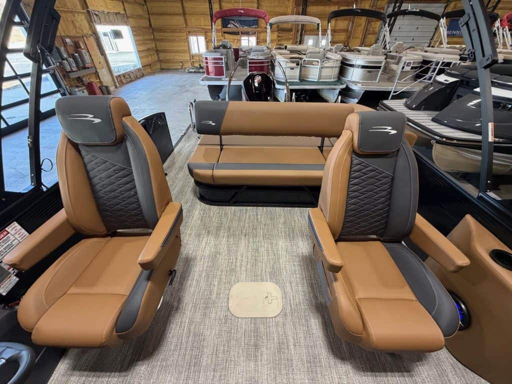 Bennington 23 SSB boat seats with comfortable tan and black upholstery. Perfect for leisure and wate.