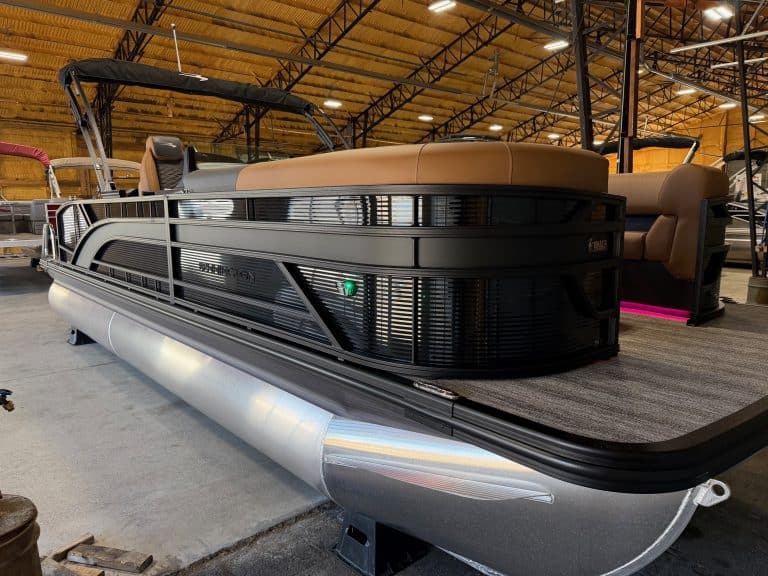 Luxury Bennington 23 SSB pontoon boat displayed at Hall's Sport Center. Perfect for family outings a.