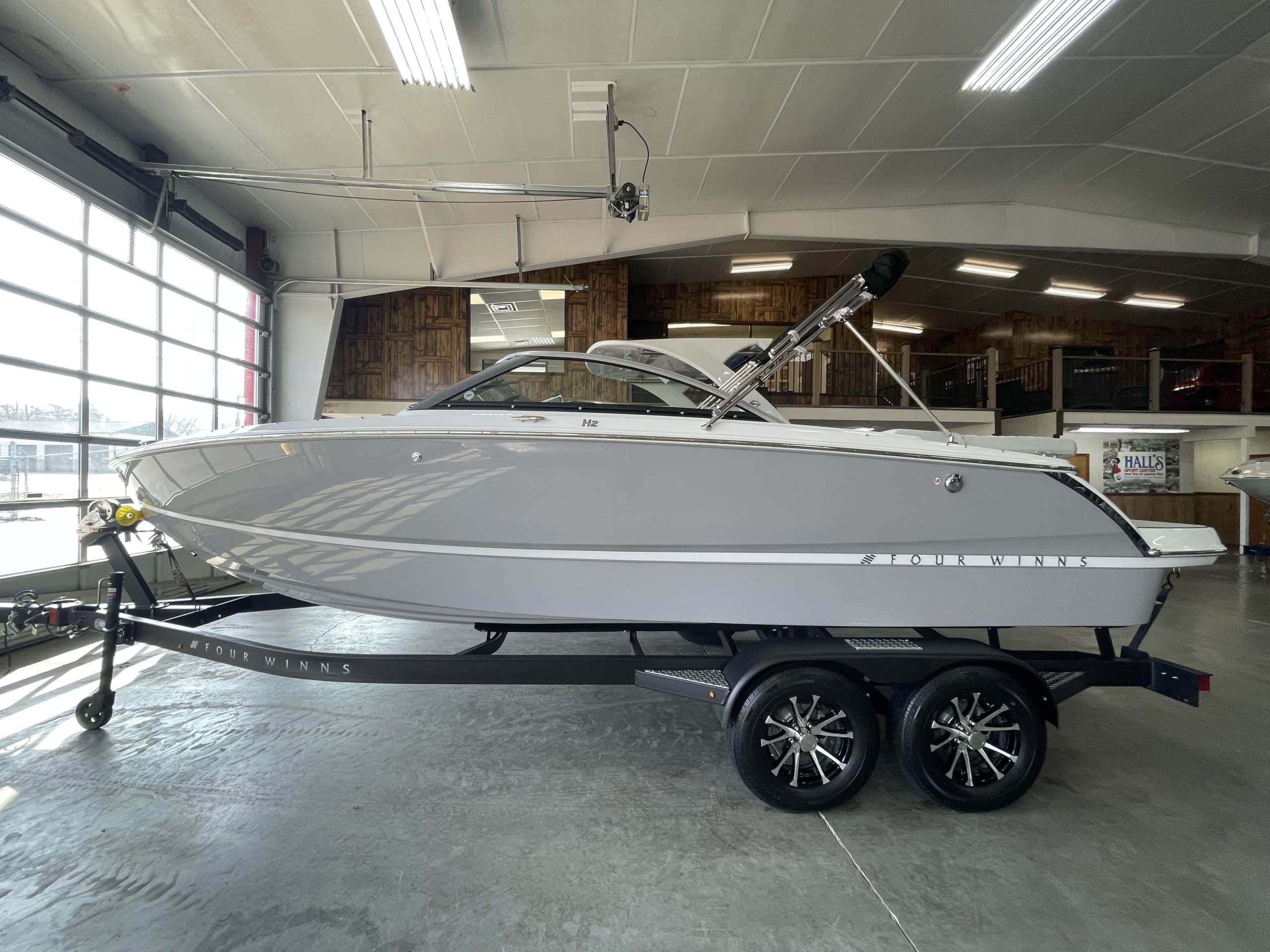 New Four Winns H2 FREEDOM boat on trailer at Hall's Sport Center.