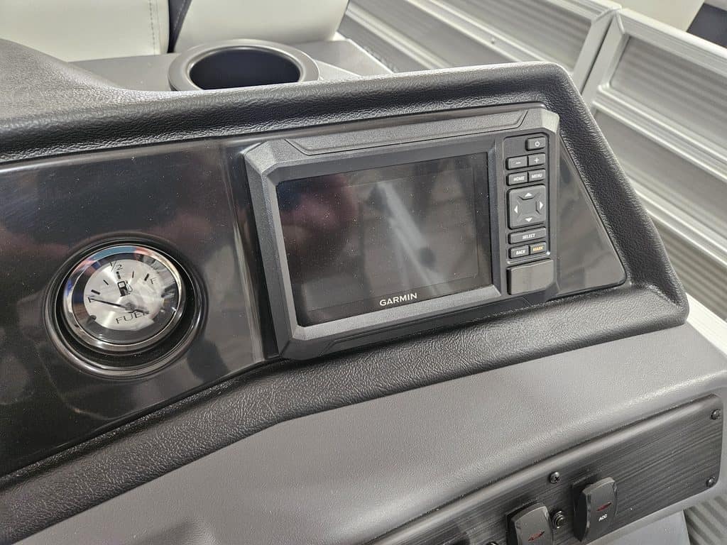 Boat dashboard featuring Garmin GPS and analog gauge.