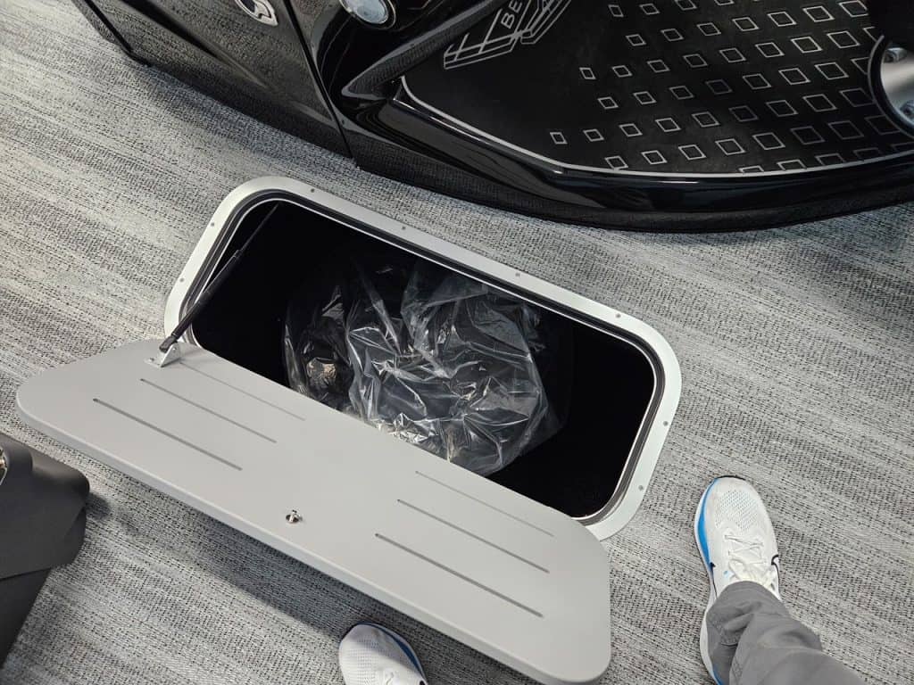 Electric vehicle charging station with a car and a person in sneakers nearby.