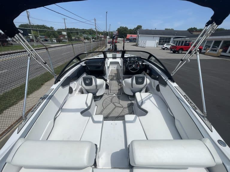 Interior view of a 2018 Scarab 195 G speedboat with seating and steering wheel.