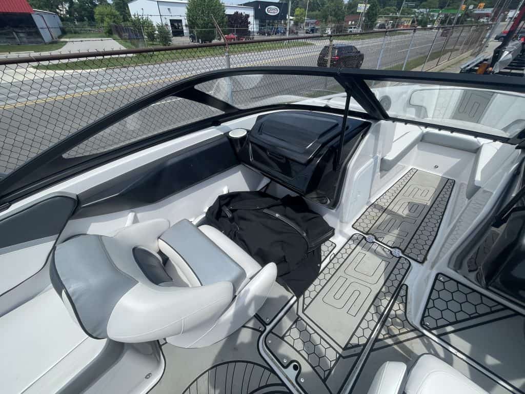 Interior view of a 2018 Scarab 195 G boat with seating and controls.
